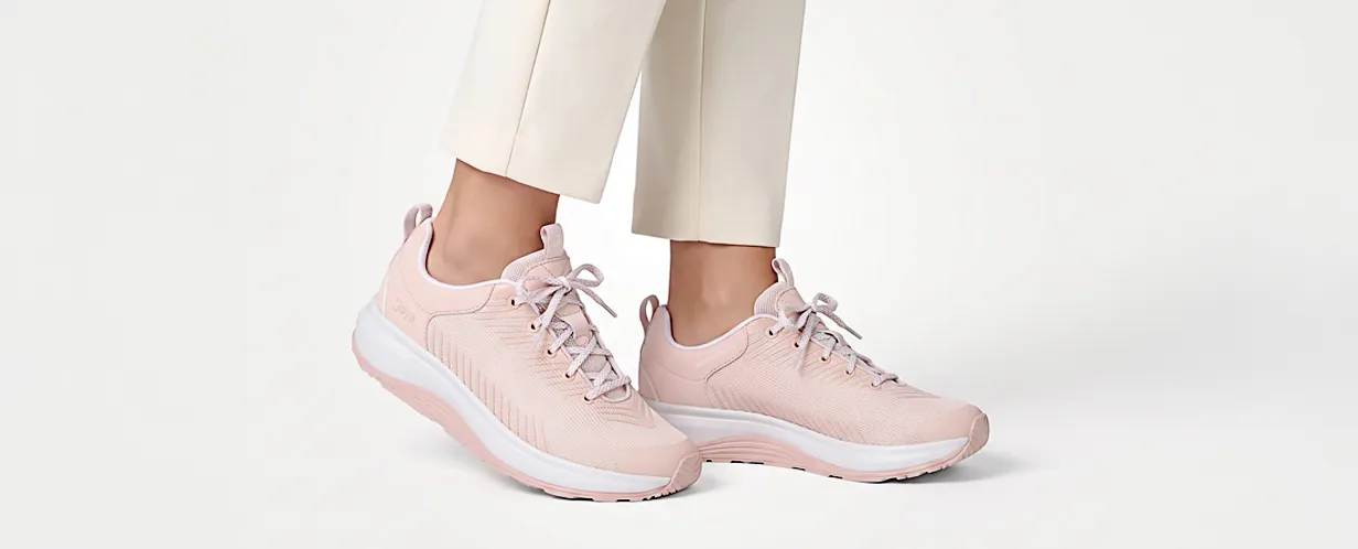 Frau trägt rosafarbene Damen-Sneaker mit Schnürung, atmungsaktivem Obermaterial und weißer Komfortsohle